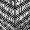Black and white geometric facade showing modern architecture with repetitive patterns.